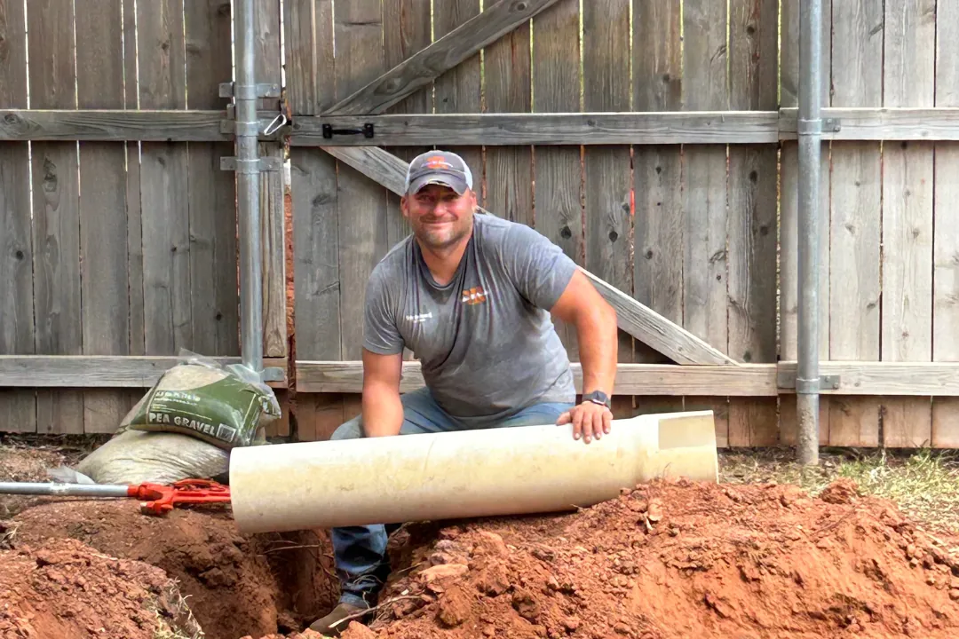 Large-diameter pipe being set in a trench