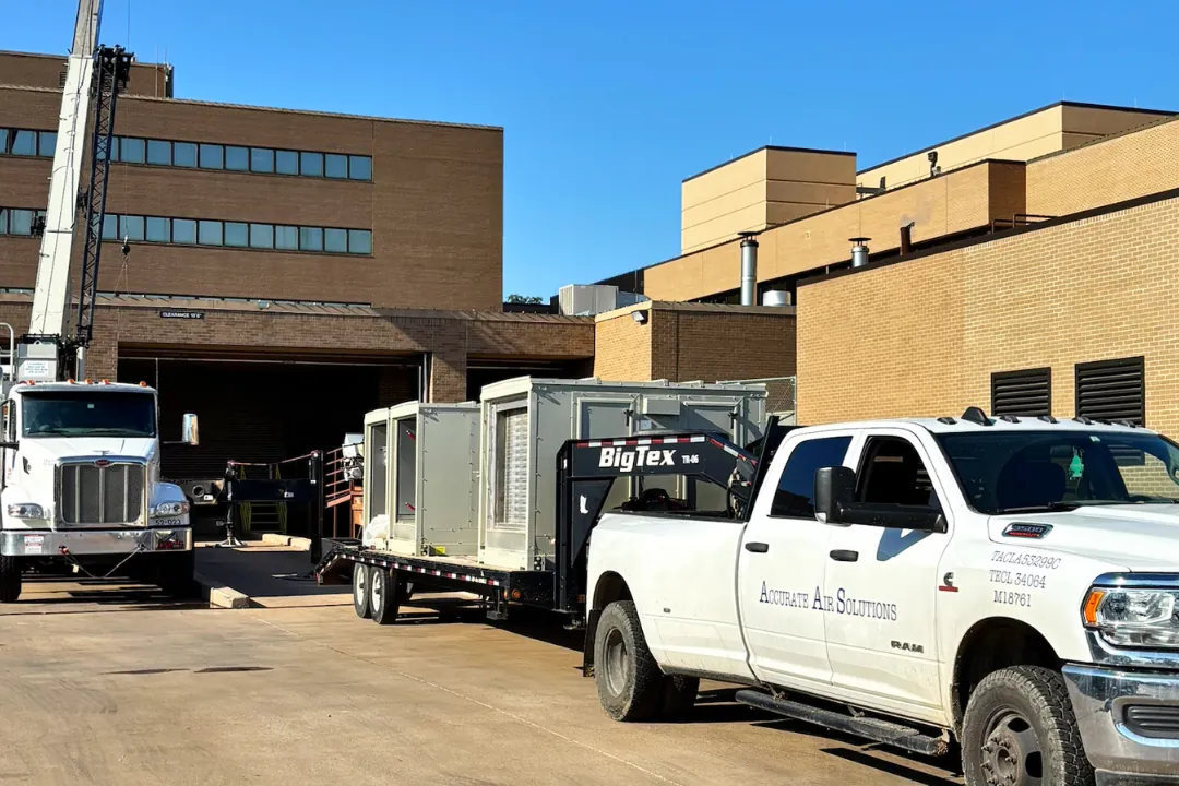 Accurate Air Solutions trucks and trailers staged at a commercial site