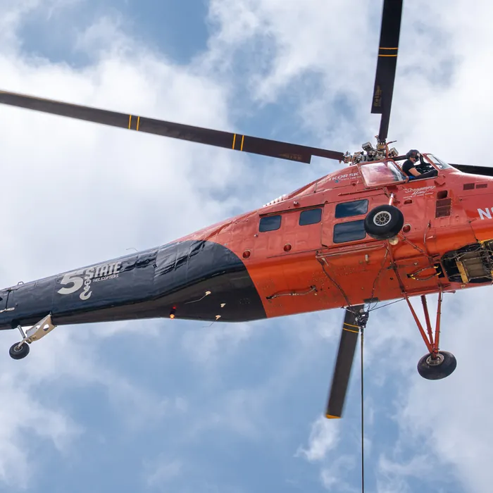 Helicopter setting equipment on a commercial roof